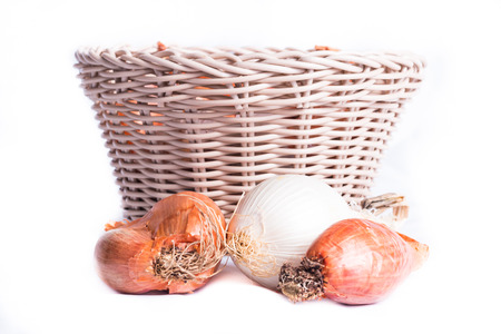 shallot in a wicker basket on a white backgroundの写真素材