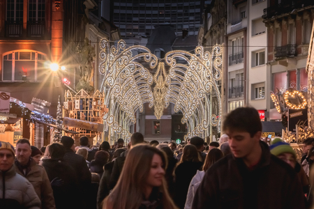 Mulhouse, France - December 23, 2017: Happy people, dressed warmly for the winter walk at night in the Christmas market on a winter dayのeditorial素材