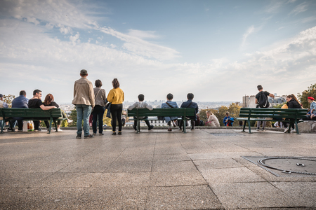 Paris, France - October 6, 2018: tourists seen from behind admire the view of Paris from the forecourt of the Sacre Coeur near Montmartre on a summer dayのeditorial素材