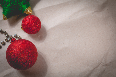 happy christmas concept with red decoration on old wooden board and writing space on paperの写真素材