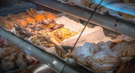 appetizing Portuguese pastries on display in the window of a pastry shopの写真素材