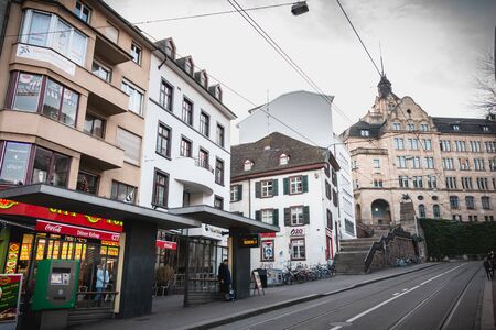 Basel, Switzerland - December 25, 2017 - Passengers waiting for the arrival of an electric tram in a...