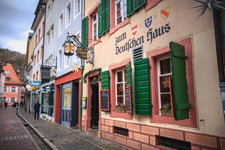 Freiburg im Breisgau, Germany - December 31, 2017: People walking on a small cobblestone street with...