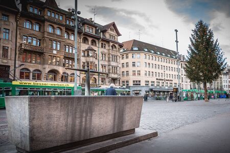 Basel, Switzerland - December 25, 2017 - people walk quietly on the market place decorated with his...