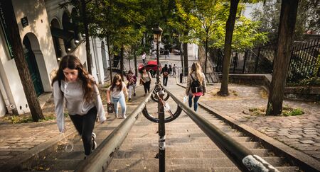 Paris, France - October 6, 2018: people move on the famous staircase of the Montmartre district a...