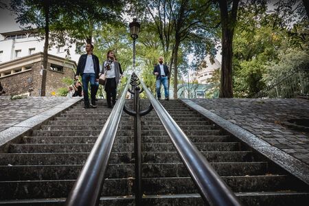 Paris, France - October 6, 2018: people move on the famous staircase of the Montmartre district a...