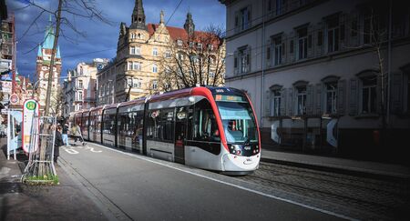 Freiburg im Breisgau, Germany - December 31, 2017: Electric tram passing a tram station on a winter...