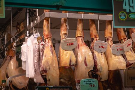 Toledo, Spain - April 27, 2018 - Shop window of appetizing cold cuts and smoked Spanish ham on a...