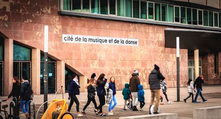 Strasbourg, France - December 28, 2017: People dressed warmly walking in front of the City of Music and Dance on a winter dayのeditorial素材
