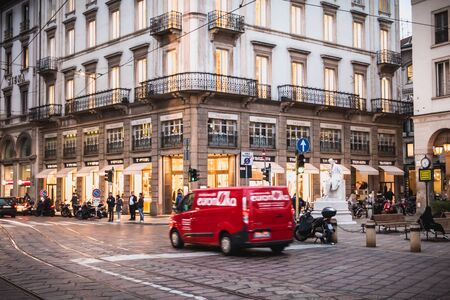 Milan, Italy - November 2, 2017: Pedestrians and car traffic on a typical shopping street in...