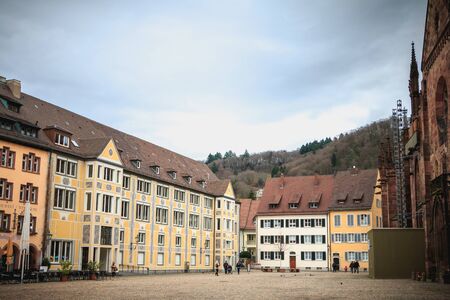 Freiburg im Breisgau, Germany - December 31, 2017: People dressed warmly walking on the paved square of the cathedral on a winter dayのeditorial素材