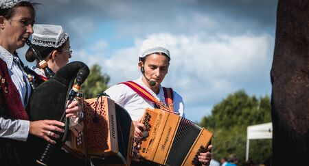 Bretignolles sur Mer, France - July 14, 2016 : accordionist and bagpiper in a traditional folk dance...