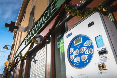 Marseillan, France - December 30, 2018: condom distributor in front of a pharmacy in the city center...