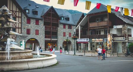 Saint-Lary-Soulan, France - August 20, 2018: atmosphere and architecture in the city center where people go for a walk on a summer dayのeditorial素材