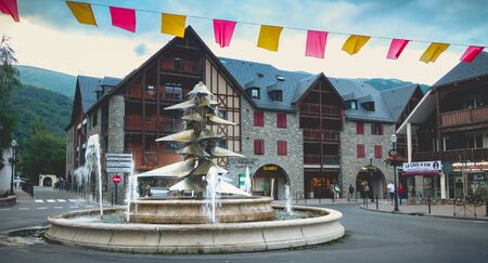Saint-Lary-Soulan, France - August 20, 2018: atmosphere and architecture in the city center where people go for a walk on a summer dayのeditorial素材