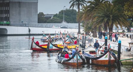 Aveiro, Portugal - May 7, 2018: Tourists walk on famous Moliceiros on a spring evening, traditional boats used to harvest seaweeds in the pastのeditorial素材