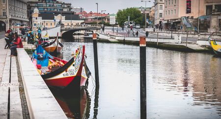 Aveiro, Portugal - May 7, 2018: view at the dock of the famous Moliceiros, traditional boats that used to harvest algae once and now transport tourists to the city canalsのeditorial素材