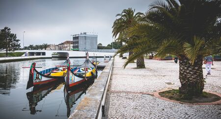 Aveiro, Portugal - May 7, 2018: view at the dock of the famous Moliceiros, traditional boats that used to harvest algae once and now transport tourists to the city canalsのeditorial素材