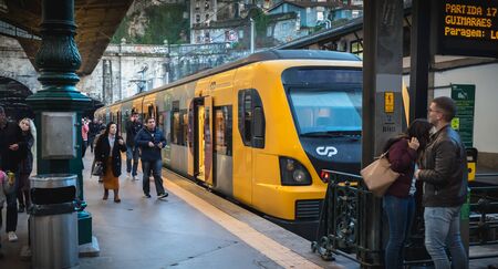 Porto, Portugal - November 30, 2018: Interior of Porto Sao Bento train station where people walk on the dock near the train stationary on a winter dayのeditorial素材