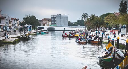Aveiro, Portugal - May 7, 2018: view at the dock of the famous Moliceiros, traditional boats that used to harvest algae once and now transport tourists to the city canalsのeditorial素材