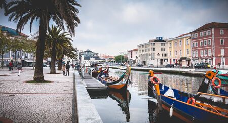 Aveiro, Portugal - May 7, 2018: view at the dock of the famous Moliceiros, traditional boats that used to harvest algae once and now transport tourists to the city canalsのeditorial素材