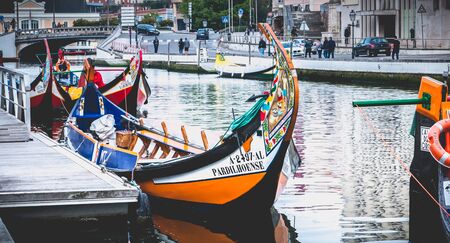 Aveiro, Portugal - May 7, 2018: view at the dock of the famous Moliceiros, traditional boats that used to harvest algae once and now transport tourists to the city canalsのeditorial素材