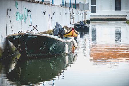 Aveiro, Portugal - May 7, 2018: Small boat docked on a canal in the city on a spring day