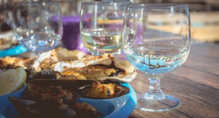 dish of oysters and mussels cooked and raw on a table near the sea in the south of France