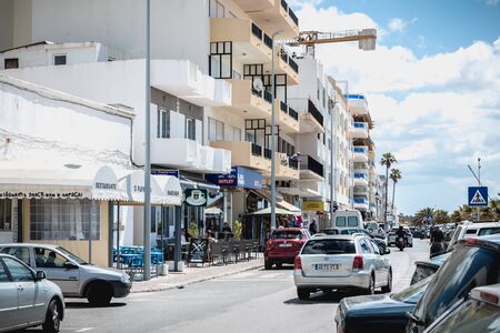 Quarteira, Portugal - May 1, 2018: Downtown shopping street atmosphere where people are walking on a spring dayのeditorial素材