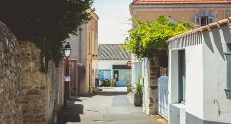 Noirmoutier, France - July 3, 2017: small typical street of the historic city center on a summer day