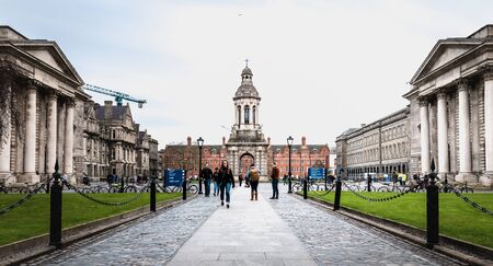 Dublin, Ireland - February 11, 2019: People walking in the courtyard of Trinity College in the city...