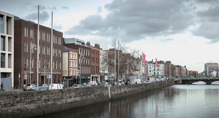 Dublin, Ireland - February 11, 2019: view of the shores of the river Liffey on a winter day, a river...
