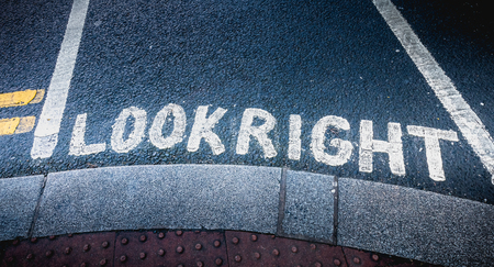 Look Right painted in white on the road on a pedestrian crossing in the city center on a winter dayの写真素材