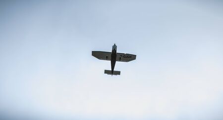 Port Joinville, France - September 16, 2018: Small passenger plane flying over Isle of Yeu near...