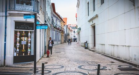 Aveiro, Portugal - May 7, 2018: People walking in a shopping street in the historic city center on a...