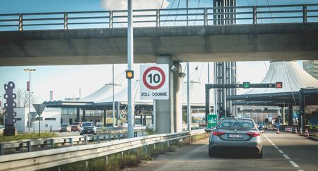 Bale, Switzerland - December 25, 2017: cars crossing customs at the border between France and...