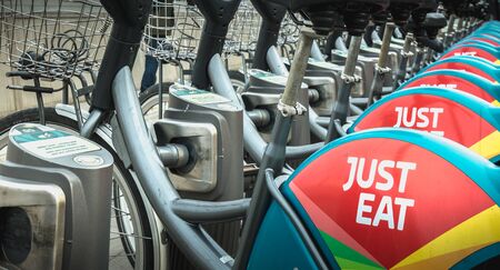 Dublin, Ireland - February 12, 2019: Detail of a shared public bike station Just Eat dublinbikes in the city center on a winter dayのeditorial素材