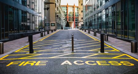 Dublin, Ireland - February 12, 2019: Fire Access Keep Clear with yellow paint on a path for...