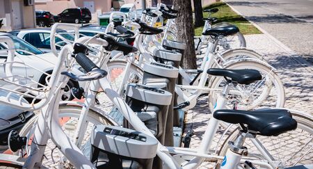 Vilamoura, Portugal - May 1, 2018: Detail of a Inframoura shared bike public docking station in the city center on a spring dayのeditorial素材