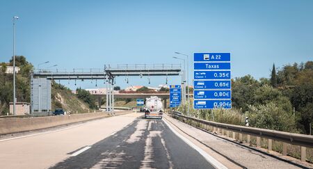 Faro, Portugal - May 4, 2018: Truck passing under a tollgate on the highway on a spring dayのeditorial素材