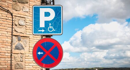 road sign prohibition of parking on the left and parking for disabled on the right in Spainの写真素材