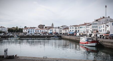 Port Joinville on the island of Yeu - September 17, 2018: view of the small port where maneuver fishing boats, tourism boats and sea shuttles going to the mainland on a summer dayのeditorial素材