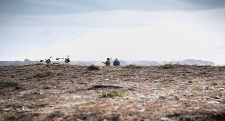 Port Joinville on the island of Yeu, France - September 18, 2018: Cycling tourists taking a break by the sea reading a map of the island on a fall dayのeditorial素材