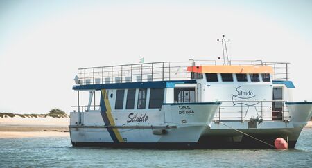 Tavira, Portugal - May 3, 2018: Tourist transport boats moored in the lagoons of the Ria Formosa Natural Park near the port of Tavira on a spring dayのeditorial素材
