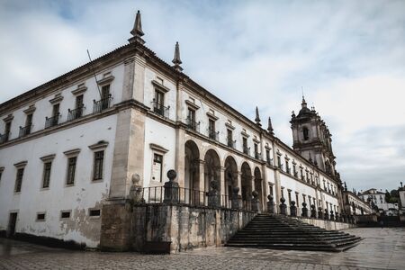 Alcobaca, Portugal - April 13, 2019: People walk in the rain in front of Alcobaca Monastery, Portugal on a spring dayのeditorial素材