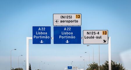 Faro, Portugal - September 16, 2018: blue road sign on A22 highway indicating the direction of Lisbon, Portugal on a summer dayのeditorial素材