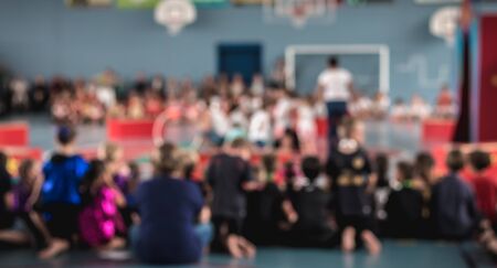 people blurred concept watching a show in a gym during the dayの写真素材