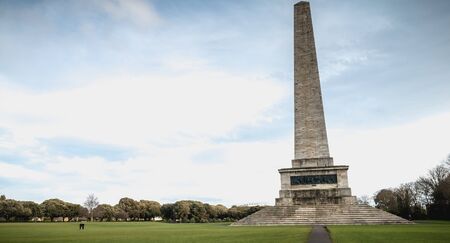 Dublin, Ireland - February 13, 2019: Tourists walking near the Testimonial Wellington obelisk in Phoenix Park, Dublin, Ireland on a winter dayのeditorial素材