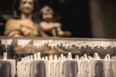 Alcobaca, Portugal - April 13, 2019: electric candle in front of the statue of the Blessed Virgin Mary in the medieval Romanesque monastery of Alcobaca on a spring dayのeditorial素材