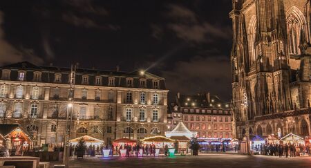 Strasbourg, France - December 28, 2017: street atmosphere at night on Notre Dame Cathedral Square where Christmas markets were installed one day in winterのeditorial素材